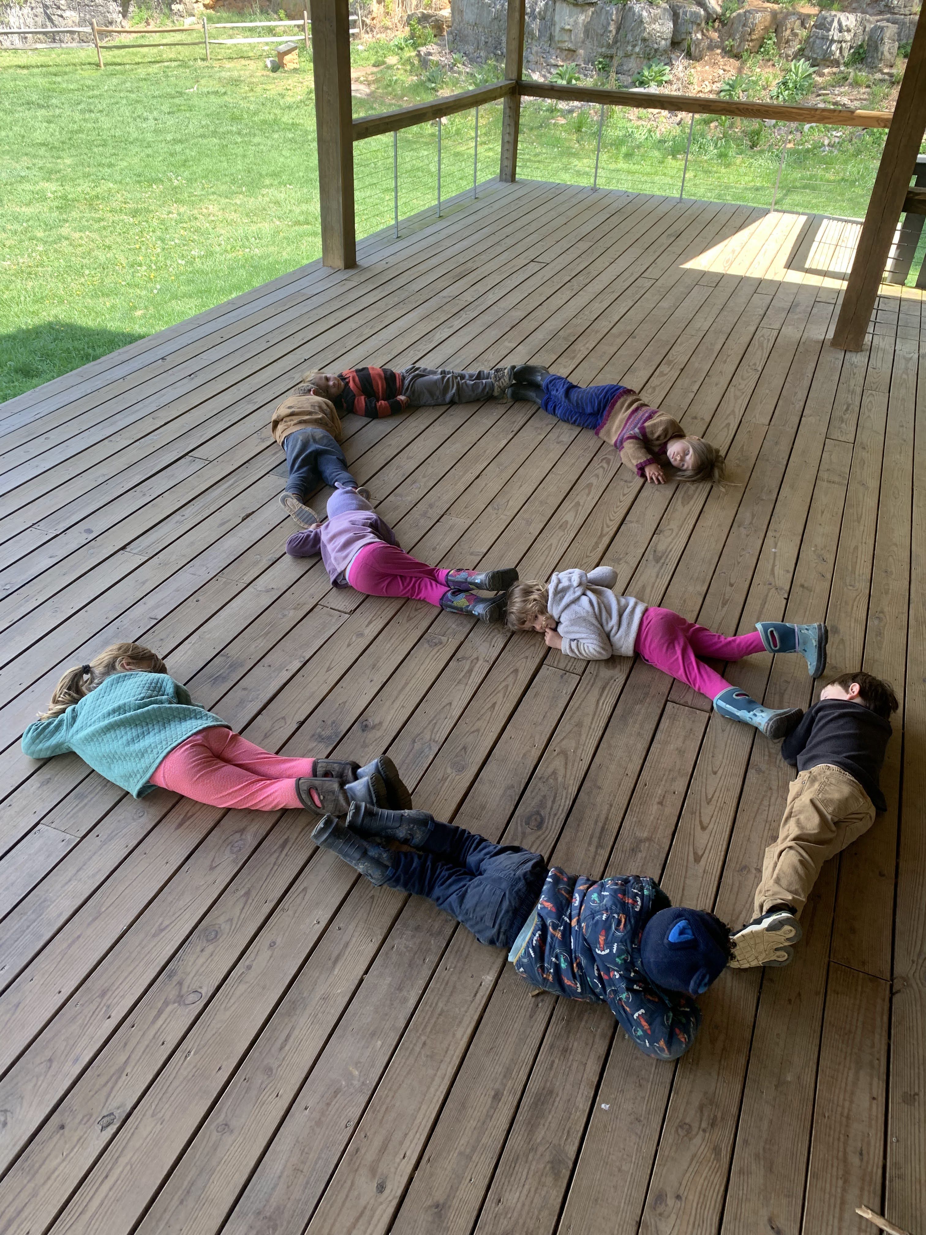 children laying in the shape of the letter S